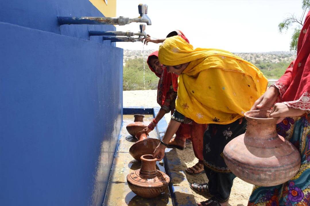 Pakistan Woman Taking Water From Solar Water Well