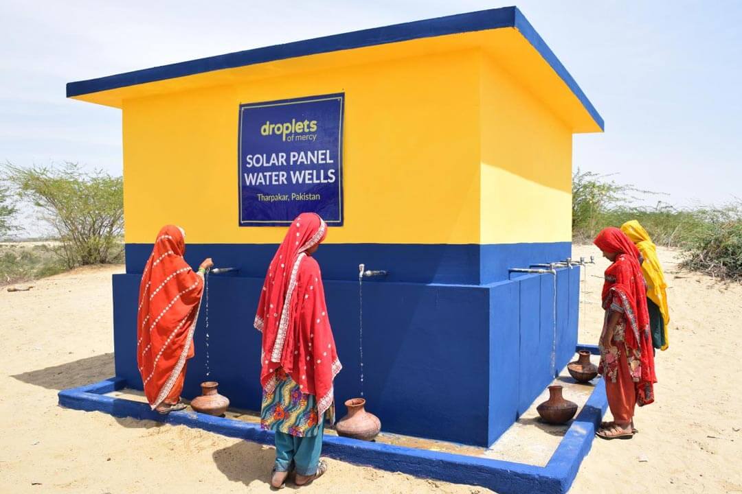 Orphans Taking Water from Solar Water Well